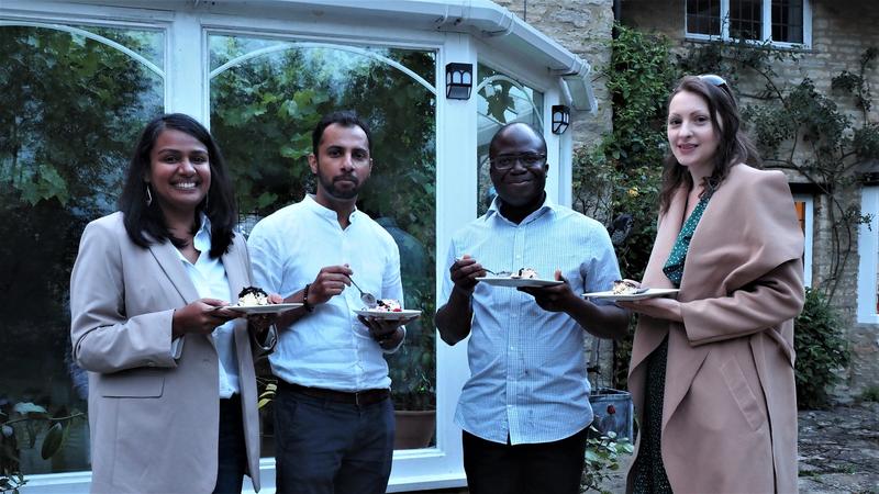 A photo of four researchers at the BBQ